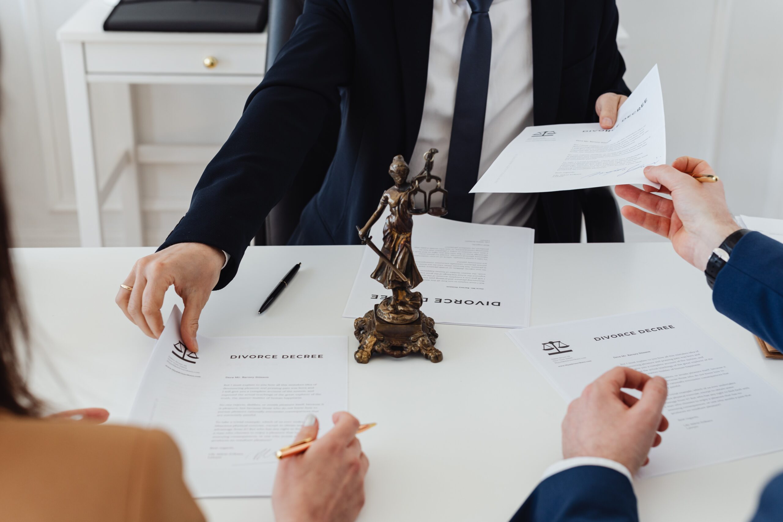 couple sitting across from lawyer reviewing divorce papers