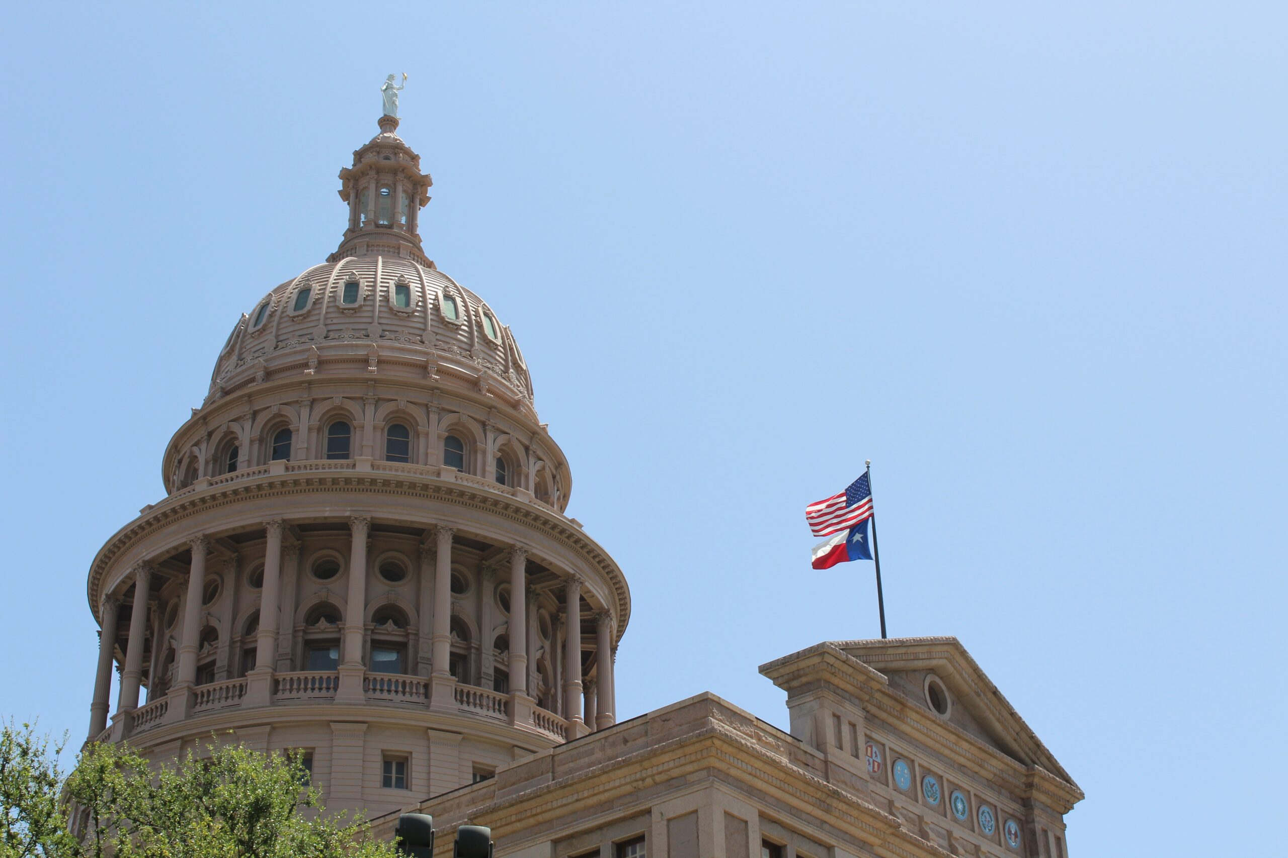 texas courthouse with american and texas flag posted