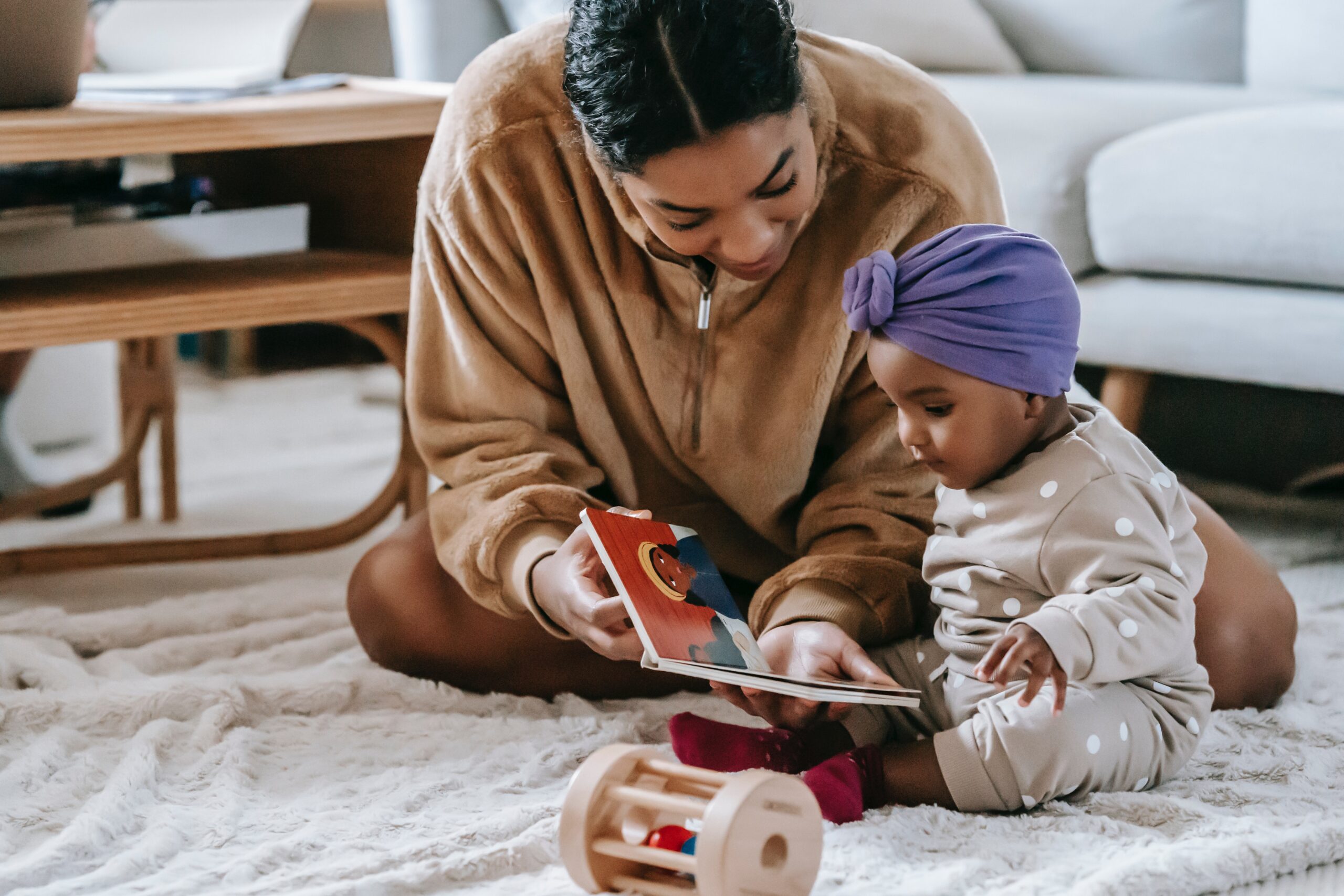 mother reading to child on playmat