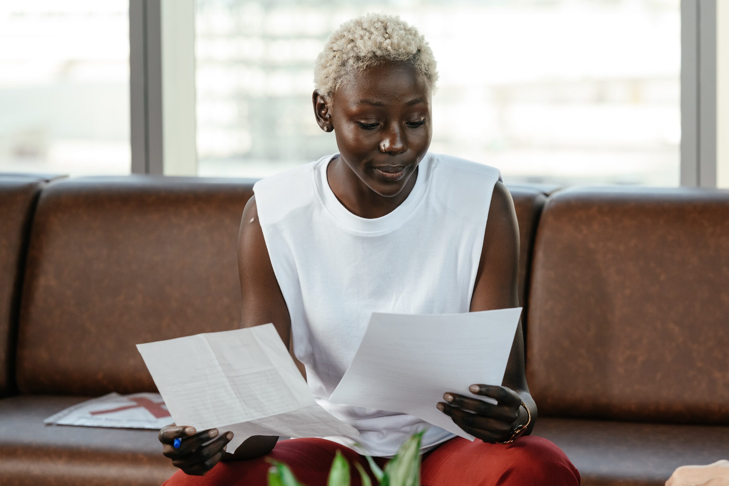 black woman examining divorce papers while sitting on a couch