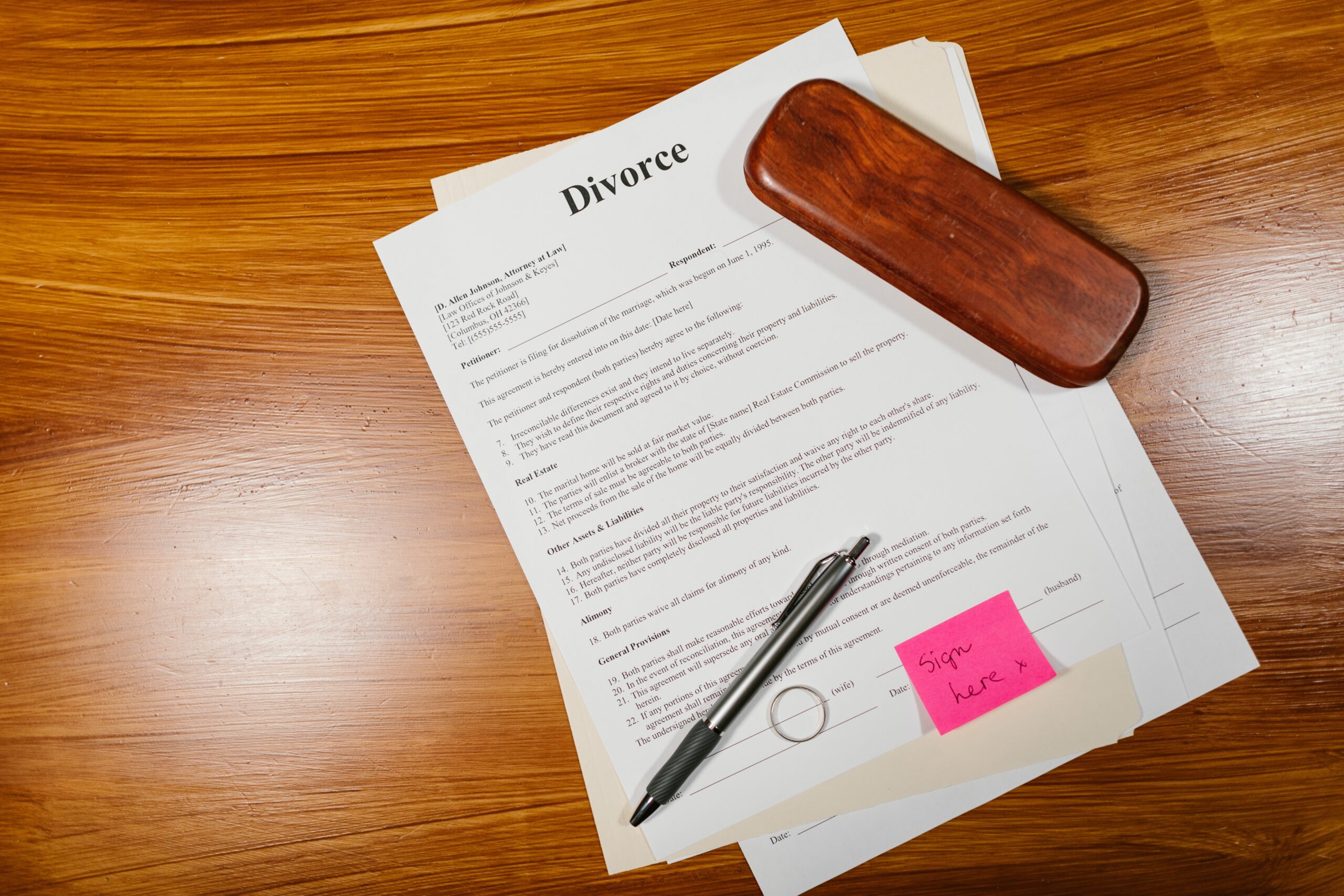 divorce papers and a pen on a wood table
