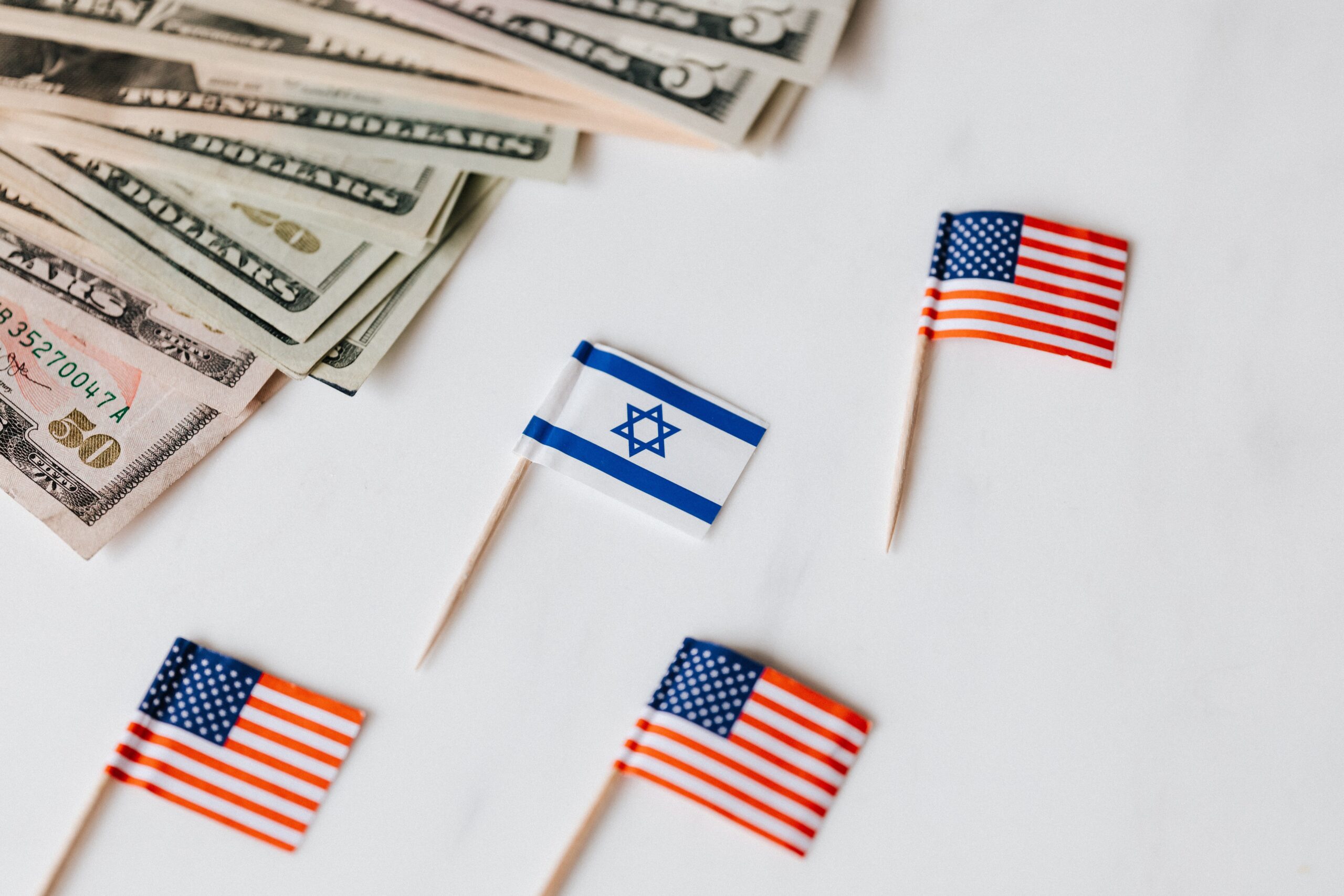 American and Israeli flags near US dollar bills