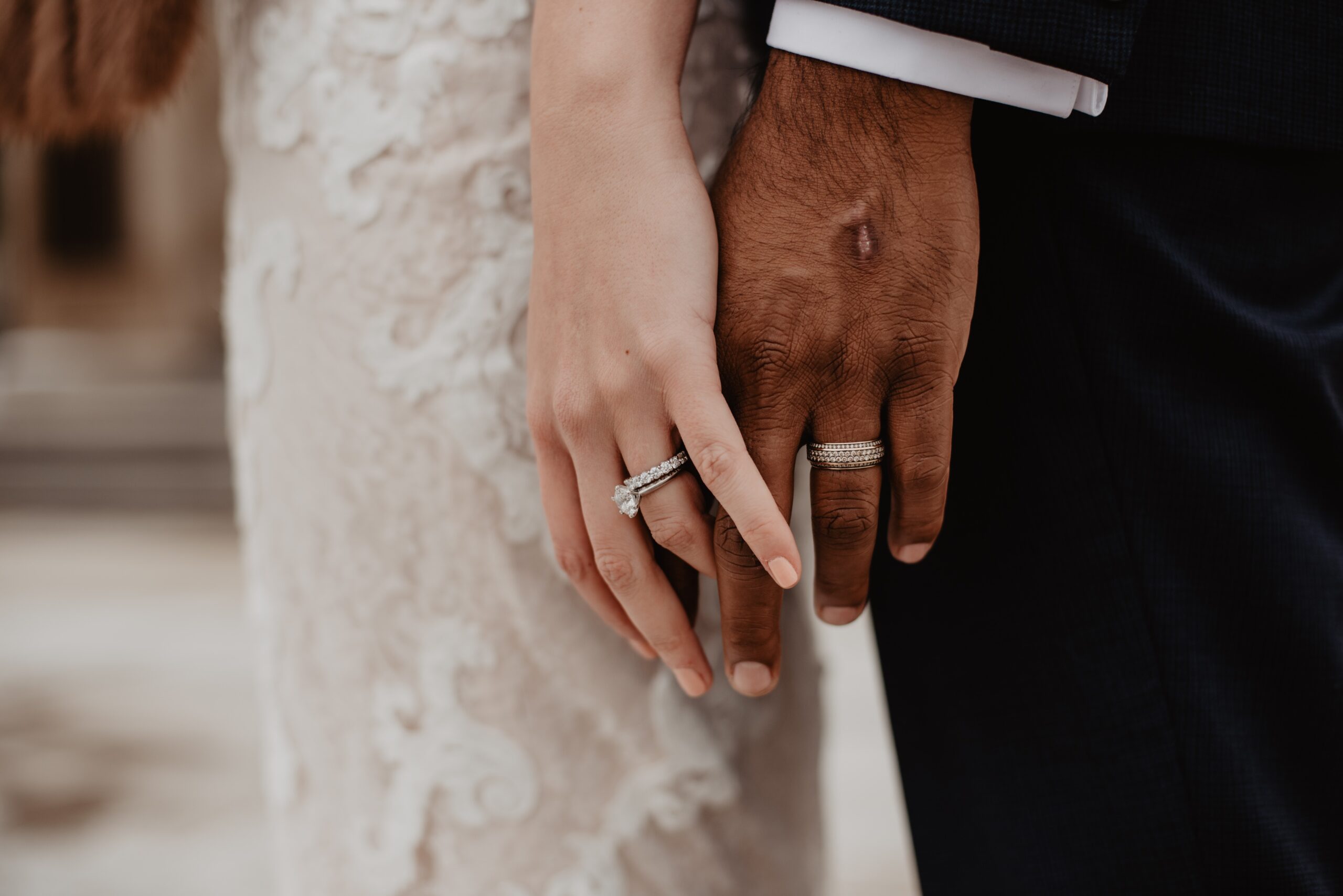 bride and groom hands with wedding rings on