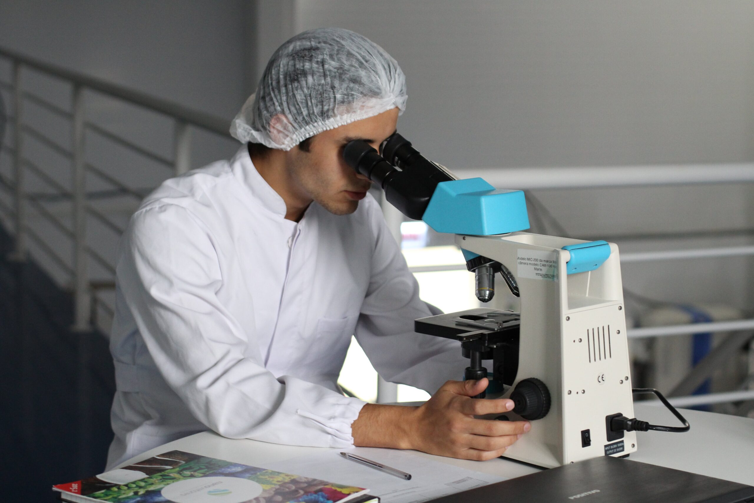 male scientist looking in a microscope