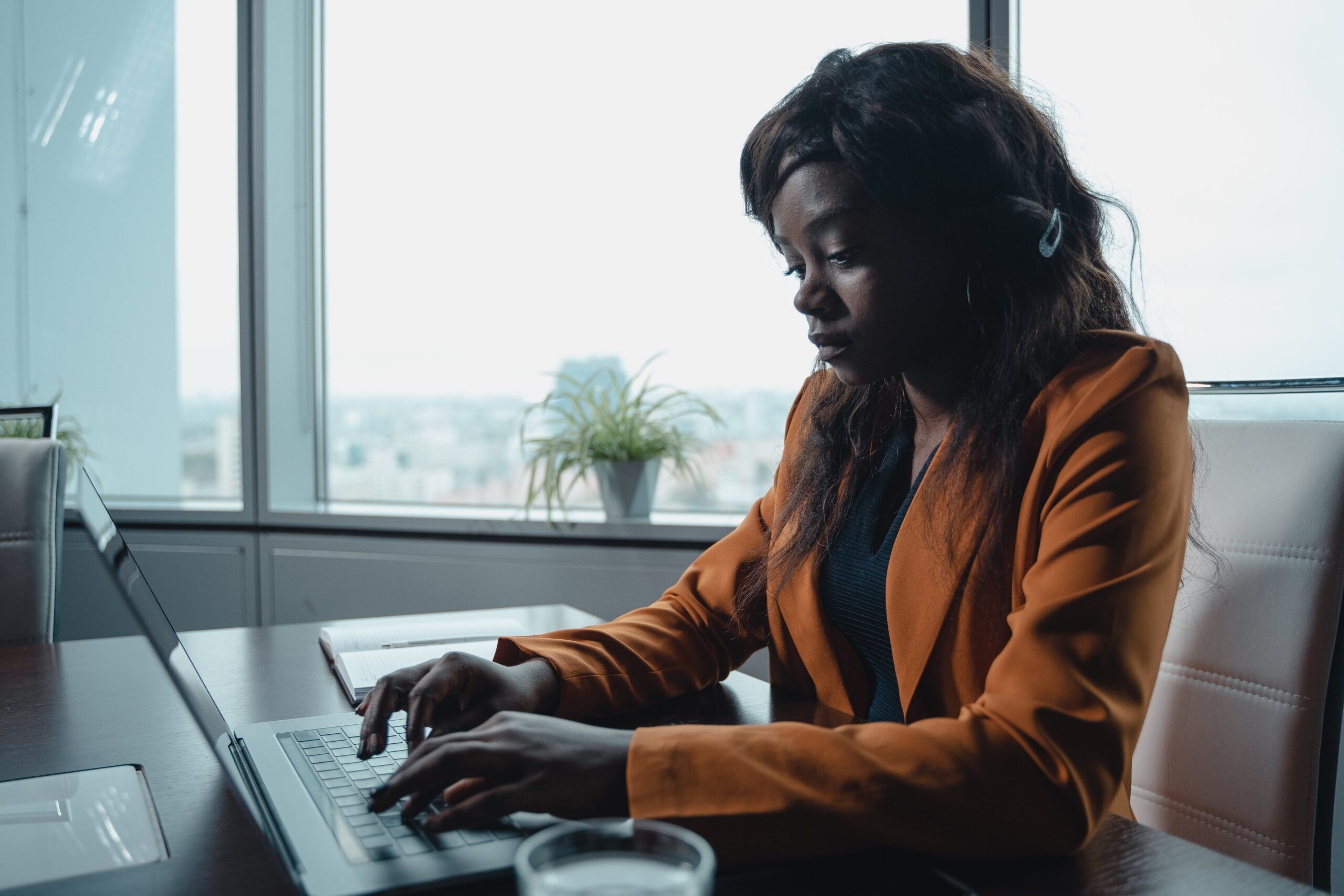 woman typing an employment verification letter on a laptop