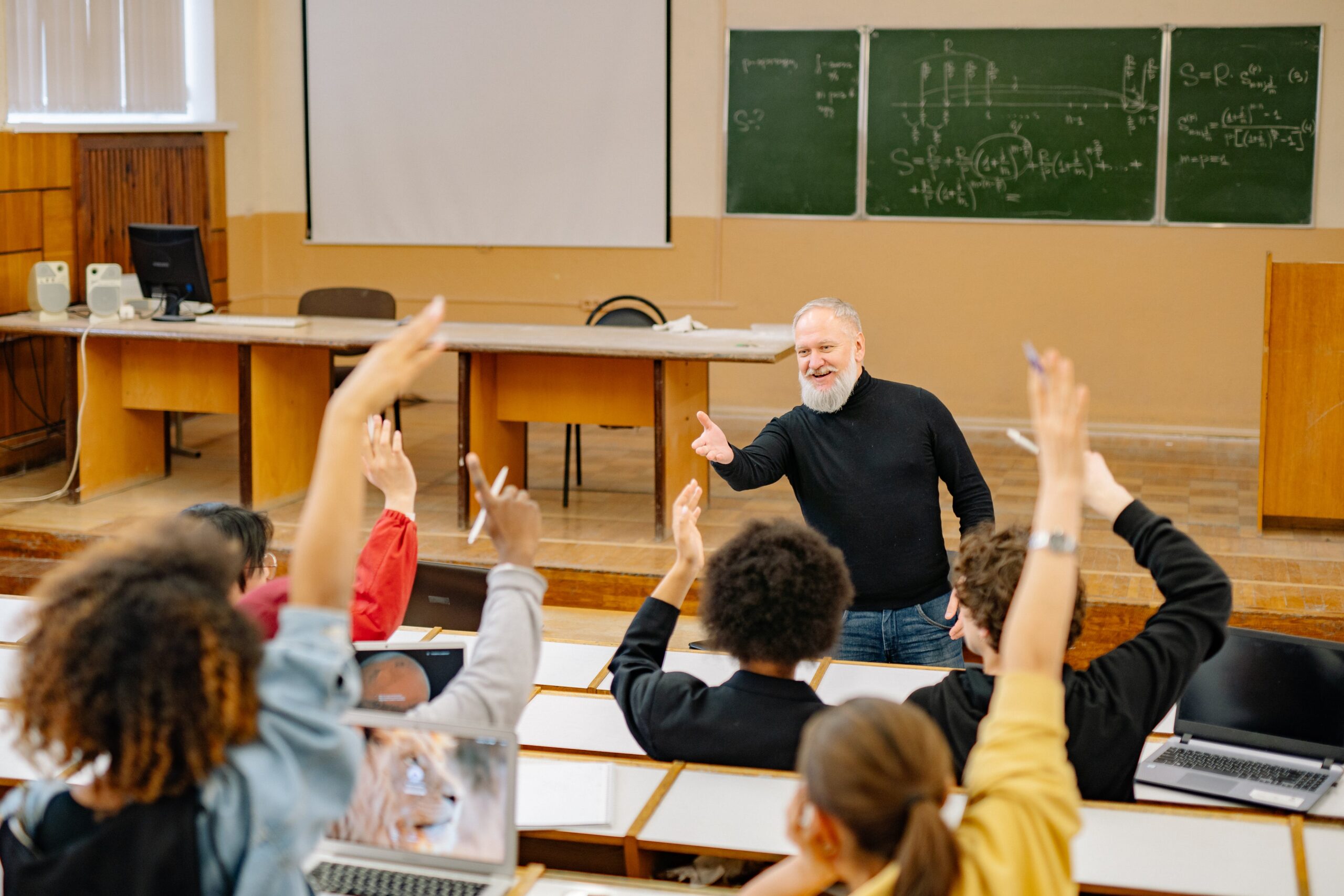 bearded professor giving lecture to students